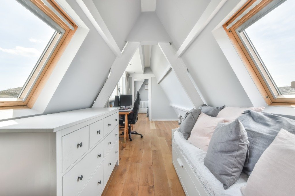 Bright attic lounge nook with daybed and Velux skylights